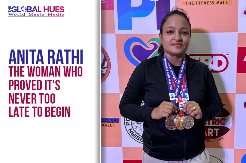 Woman with multiple medals around her neck posing in front of a sponsor backdrop; Anita Rathi poster shown on the left.